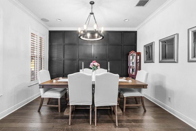 dining space featuring a chandelier, dark wood-type flooring, and ornamental molding