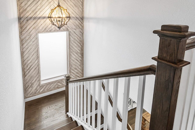 stairs with a notable chandelier and wood-type flooring