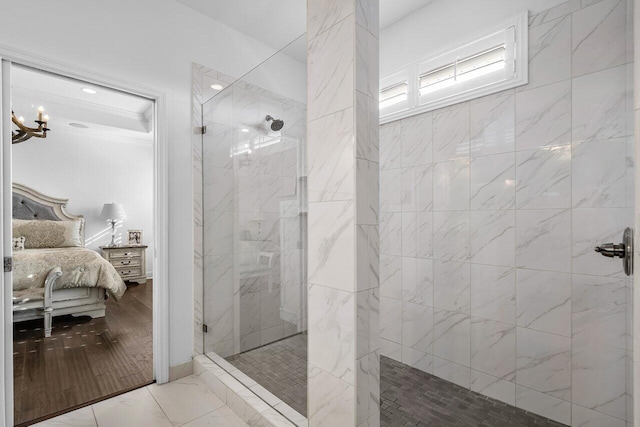 bathroom featuring tiled shower, wood-type flooring, and a notable chandelier