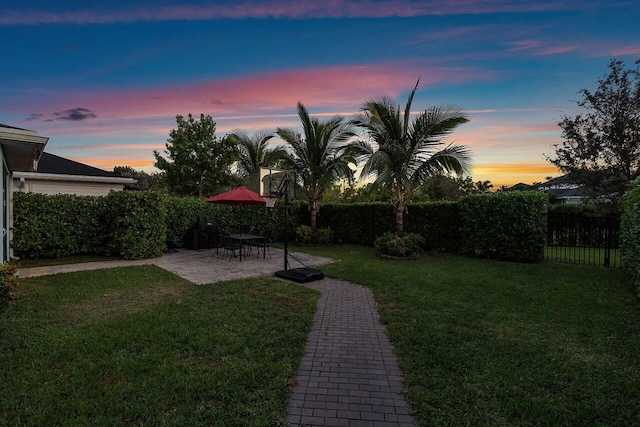 yard at dusk with a patio