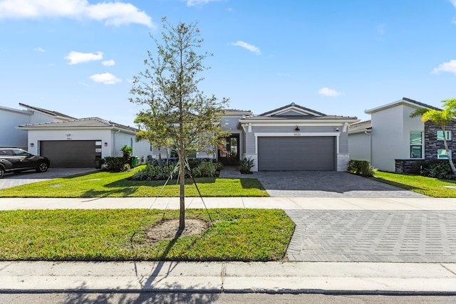 view of front facade with a front yard and a garage