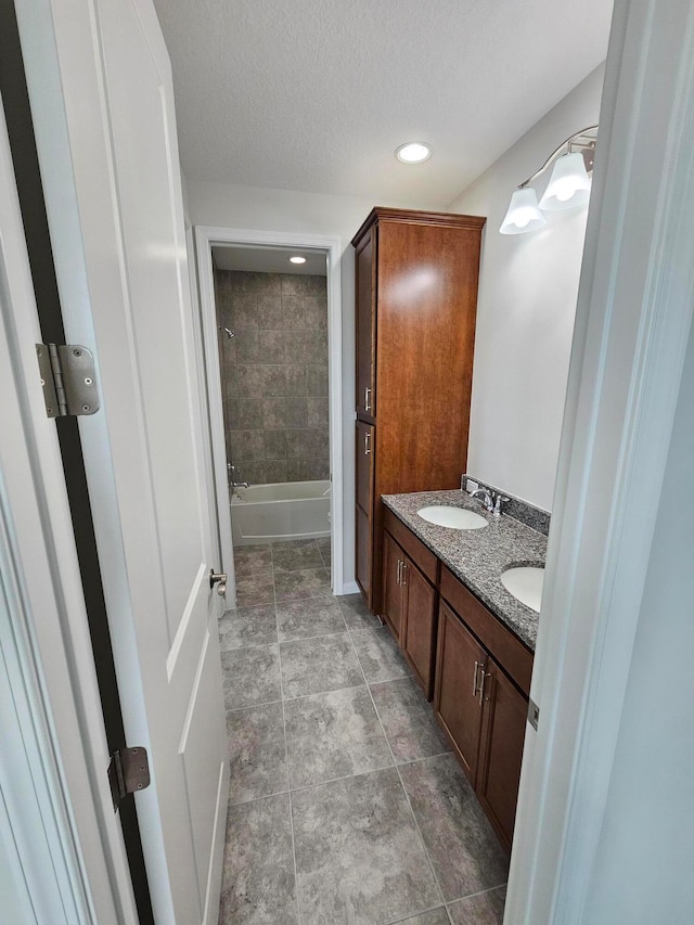 bathroom featuring tile patterned floors, vanity, and a textured ceiling