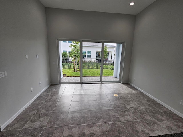 unfurnished room featuring a high ceiling