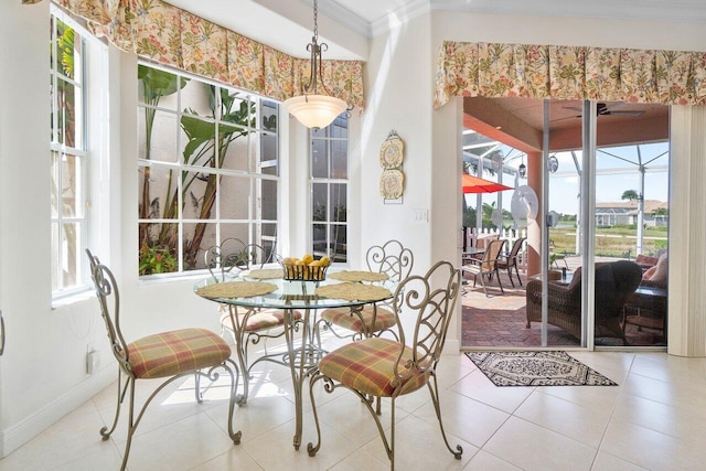 dining area with tile patterned flooring and crown molding