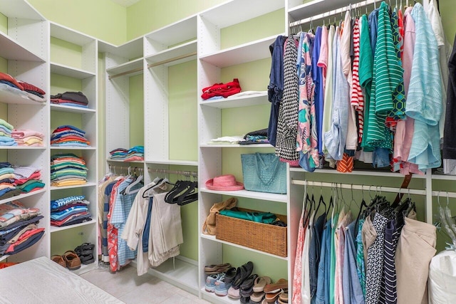 walk in closet with light tile patterned floors