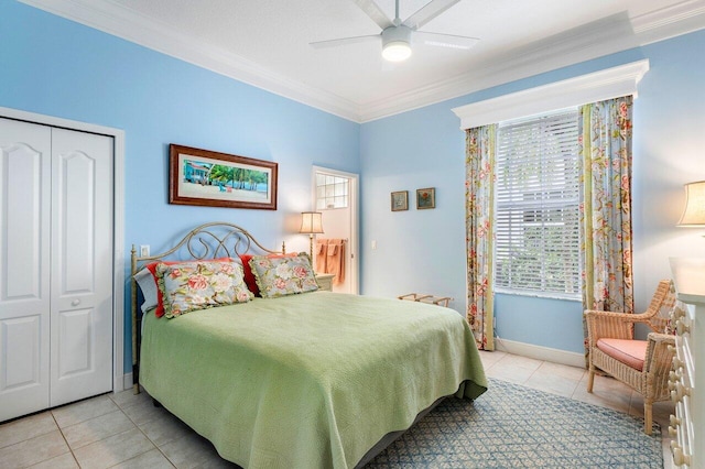 bedroom with ceiling fan, a closet, light tile patterned floors, and ornamental molding