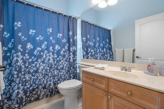 bathroom with tile patterned floors, a shower with curtain, vanity, and toilet