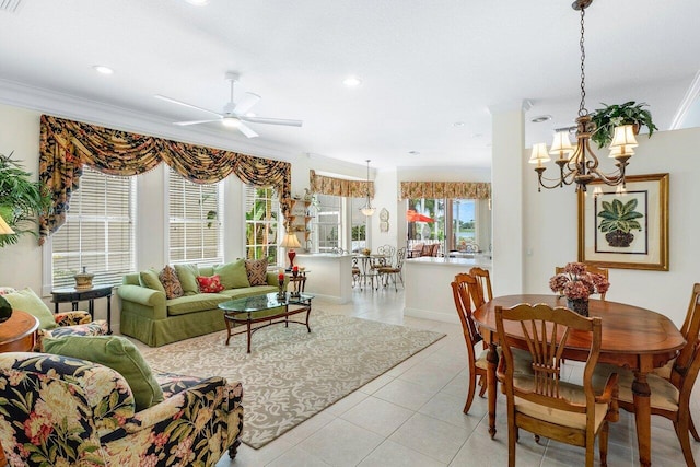 interior space featuring light tile patterned floors, ceiling fan with notable chandelier, and ornamental molding