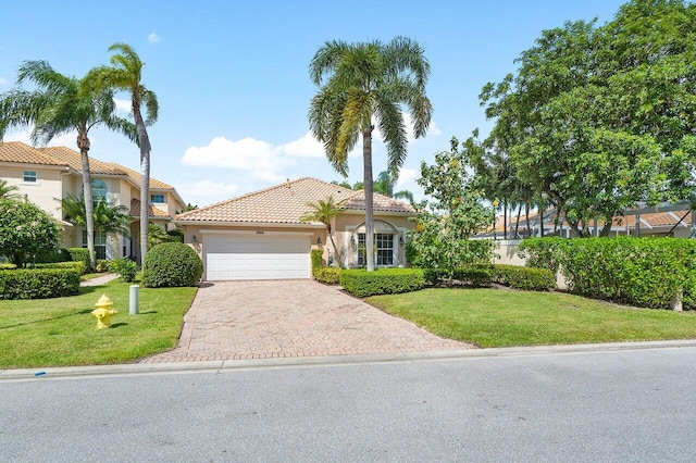 mediterranean / spanish house featuring a front lawn and a garage