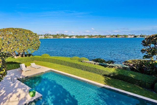 view of pool featuring a water view and a patio