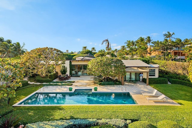 rear view of property featuring a yard and a patio