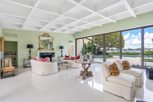 living room with beam ceiling, a premium fireplace, and coffered ceiling