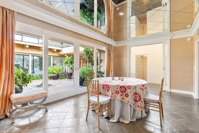 dining area with french doors and a towering ceiling