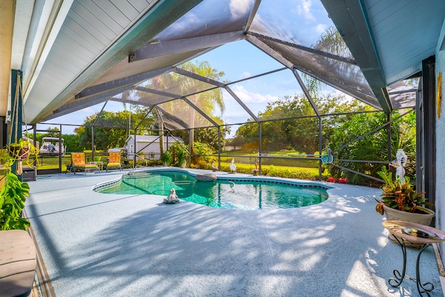 view of swimming pool featuring a lanai and a patio