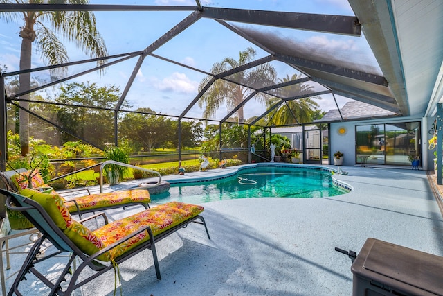 view of pool featuring glass enclosure and a patio area