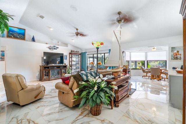 living room with ceiling fan, a fireplace, and vaulted ceiling