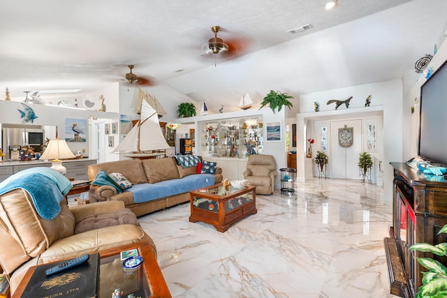 living room with a textured ceiling, vaulted ceiling, and ceiling fan