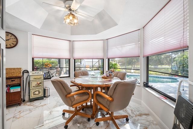 sunroom / solarium featuring ceiling fan and a healthy amount of sunlight