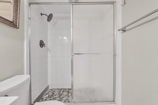 bathroom with an enclosed shower and toilet