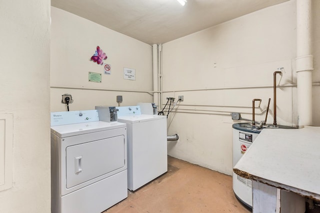 clothes washing area featuring washer and clothes dryer and water heater