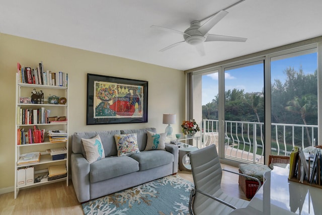 living room featuring light hardwood / wood-style floors, floor to ceiling windows, and ceiling fan