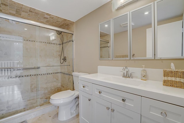 full bath featuring a stall shower, vanity, and toilet