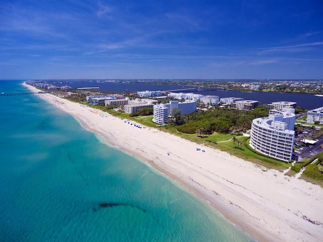 bird's eye view featuring a water view, a view of city, and a beach view