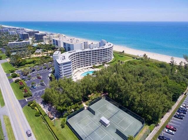 birds eye view of property with a view of the beach and a water view