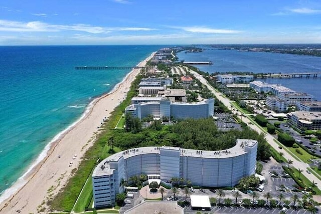 birds eye view of property featuring a view of city, a beach view, and a water view