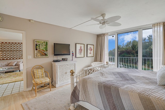 bedroom featuring ceiling fan, light hardwood / wood-style floors, and access to exterior