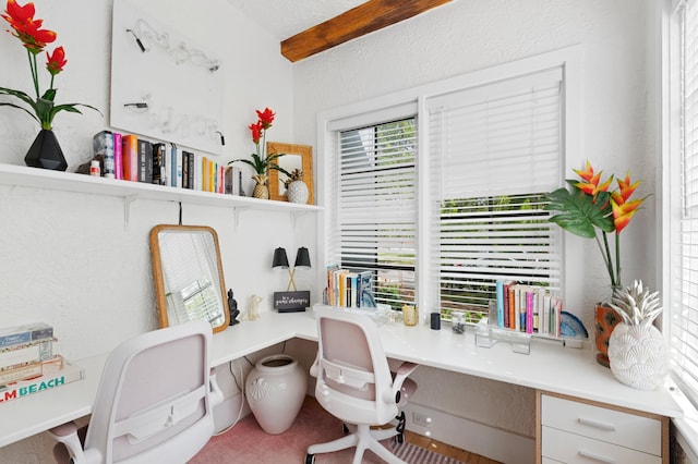 office space with built in desk and a textured ceiling