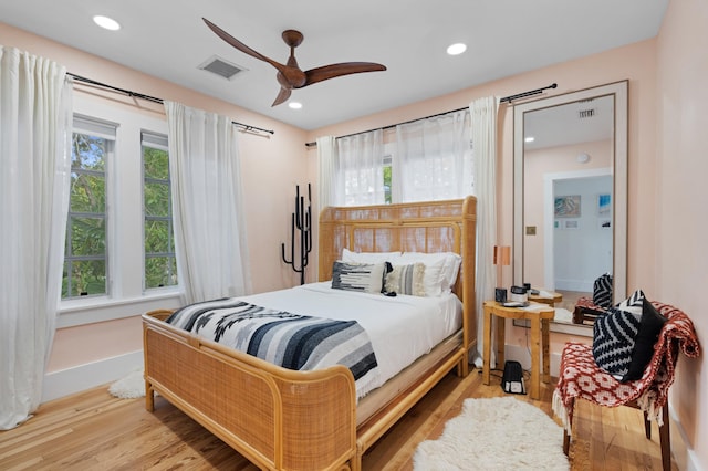 bedroom featuring light hardwood / wood-style floors and ceiling fan