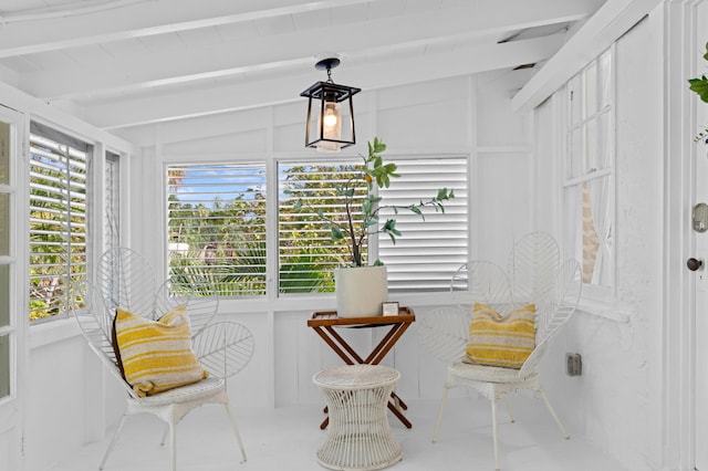 living area with lofted ceiling with beams and a wealth of natural light