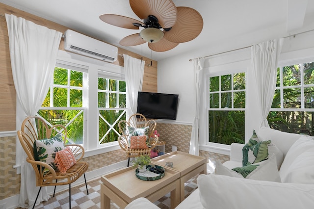 living room with an AC wall unit and ceiling fan