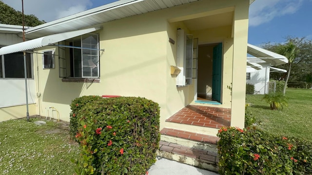 property entrance with a yard