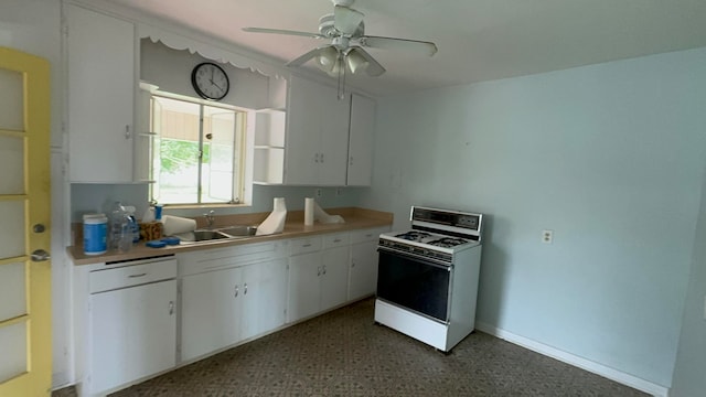 kitchen with ceiling fan, white cabinetry, white gas range, and sink