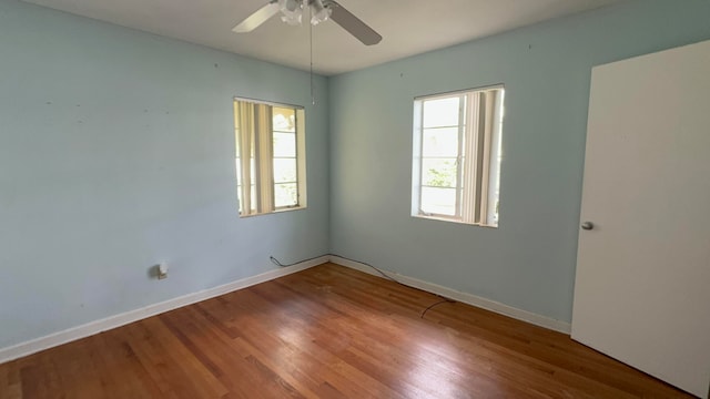 empty room featuring ceiling fan and hardwood / wood-style floors