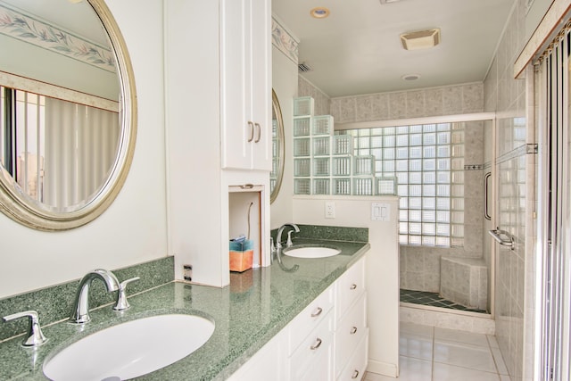 bathroom featuring walk in shower, vanity, and tile patterned flooring