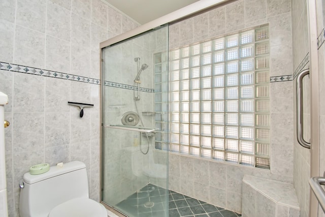 bathroom with an enclosed shower and toilet