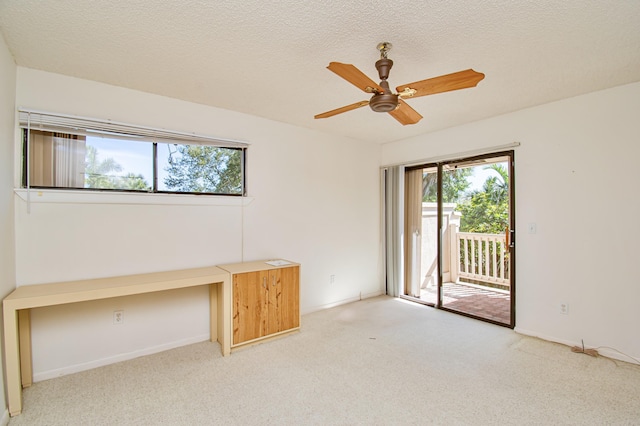 unfurnished office featuring a textured ceiling, ceiling fan, and carpet floors