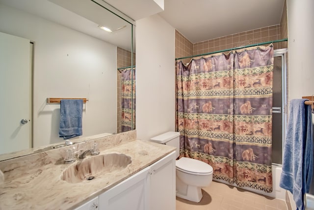 full bathroom featuring tile patterned floors, toilet, vanity, and shower / bathtub combination with curtain