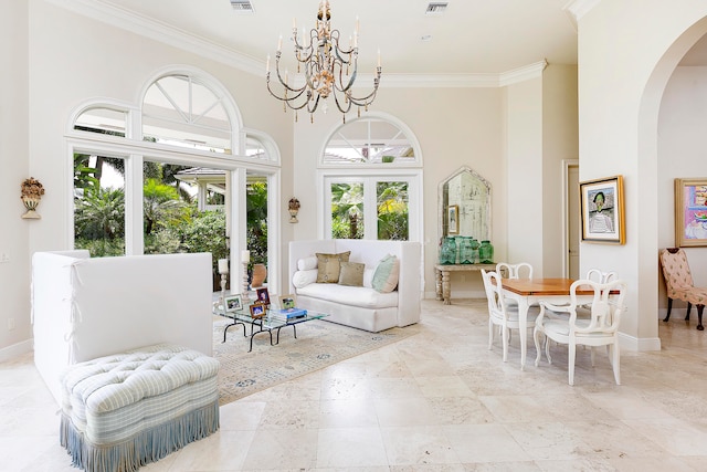 interior space featuring a high ceiling, plenty of natural light, and crown molding