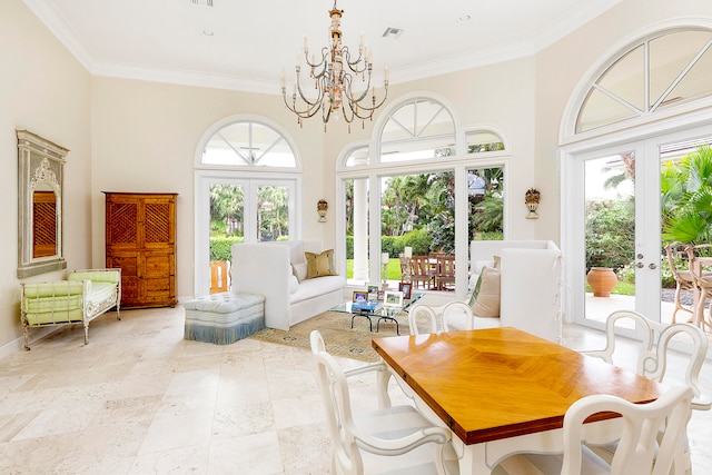 sunroom / solarium featuring a chandelier and french doors