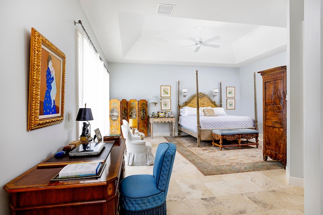 bedroom with a tray ceiling and ceiling fan