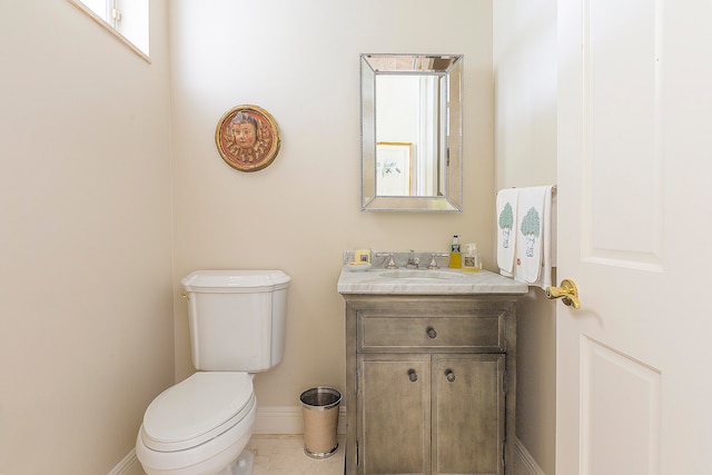 bathroom featuring tile patterned flooring, vanity, and toilet