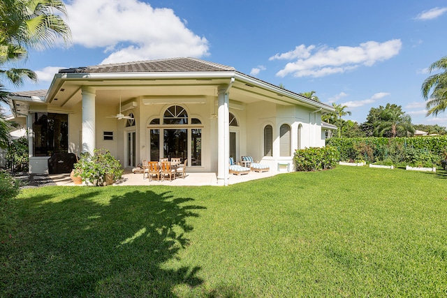 rear view of house with a yard, a patio, and ceiling fan