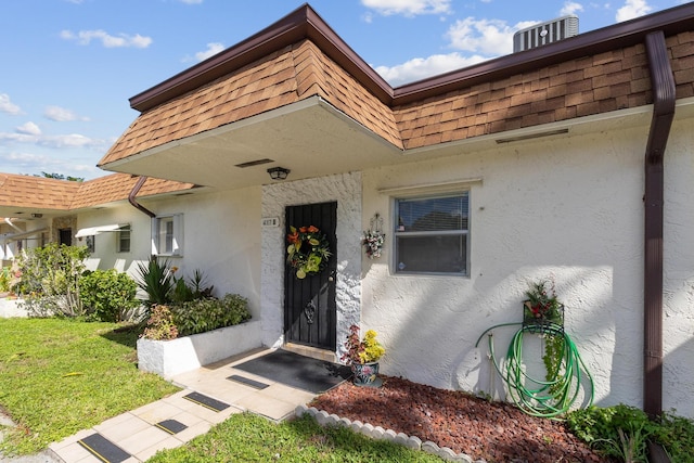 doorway to property with a lawn