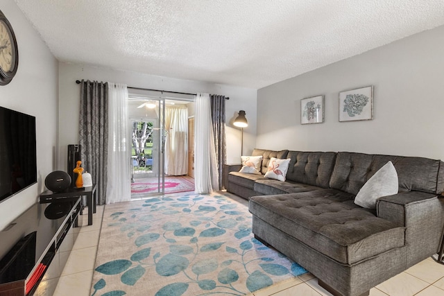 living room with a textured ceiling and light tile patterned flooring