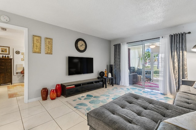 living room with light tile patterned flooring and a textured ceiling