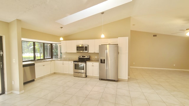 kitchen featuring appliances with stainless steel finishes, a skylight, ceiling fan, white cabinets, and hanging light fixtures